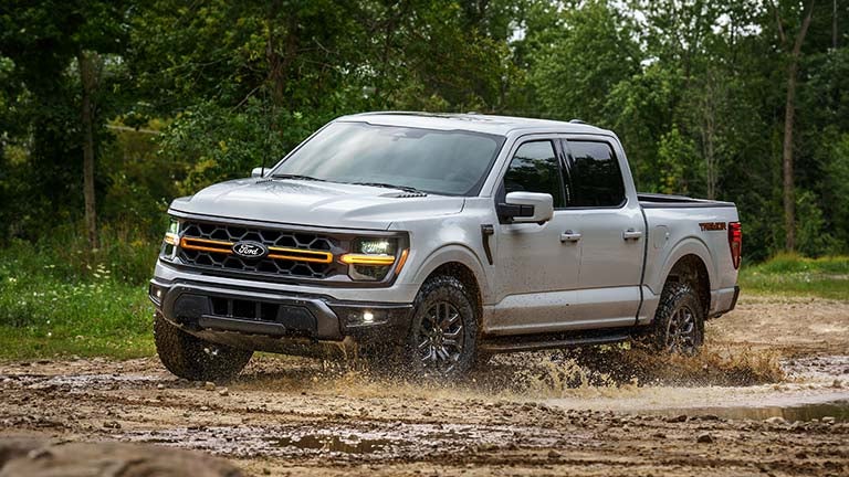 Ford F-150 driving through mud