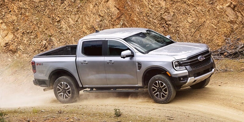 pickup truck driving off-road on dirt