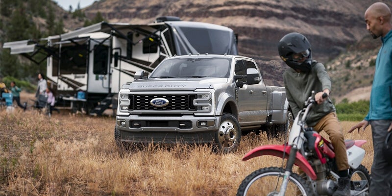 Heavy-duty truck with trailer and people.